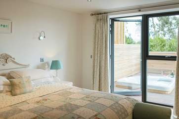 The hot tub is right outside the bedroom doors.