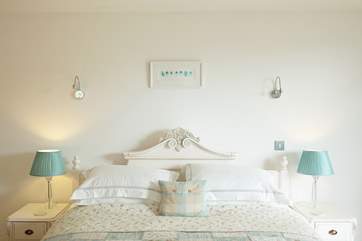The spacious bedroom has a beautiful 6' carved wooden Provencal-style bed.