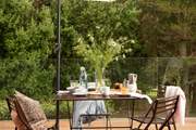Take afternoon tea on the decking at the quaint table and chairs