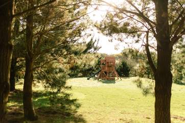 The children's play-area has a sturdy wooden play frame.