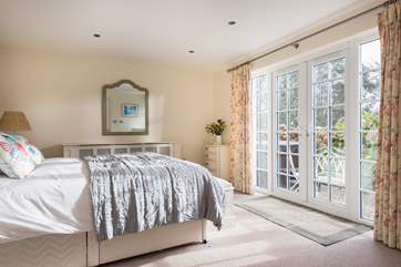 Bedroom 1 has French doors out to the terrace and hot tub.