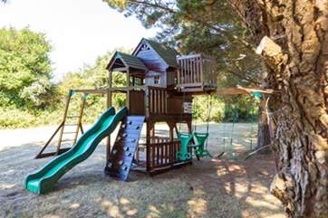 The children's play-area has a sturdy wooden play frame.