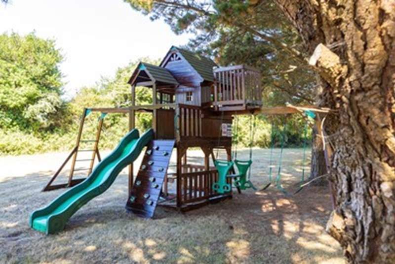 The children's play-area has a sturdy wooden play frame.