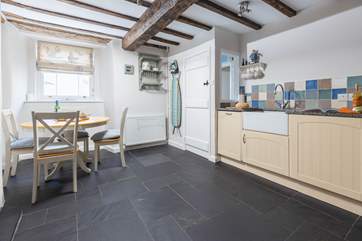 The lovely kitchen/diner has exposed beams.