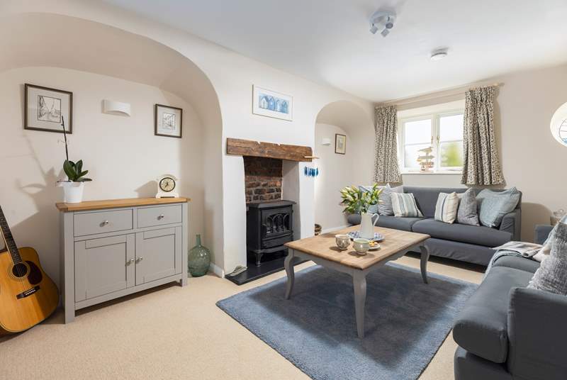 The gorgeous living-room has a wood-burner effect electric stove making this the perfect holiday cottage throughout the seasons.