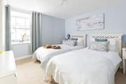 The dreamy twin bedroom is the first bedroom at the top of the stairs.