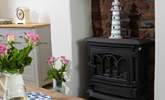 The gorgeous living-room has a wood-burner effect electric stove making this the perfect holiday cottage throughout the seasons. - Thumbnail Image