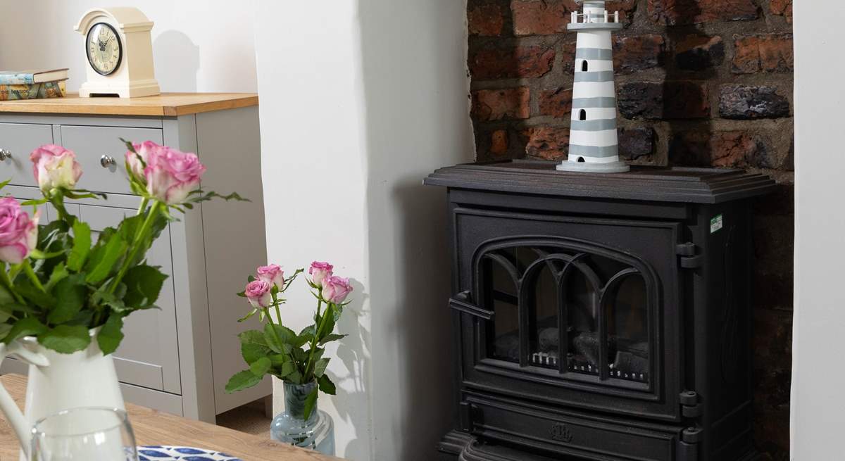 The gorgeous living-room has a wood-burner effect electric stove making this the perfect holiday cottage throughout the seasons.