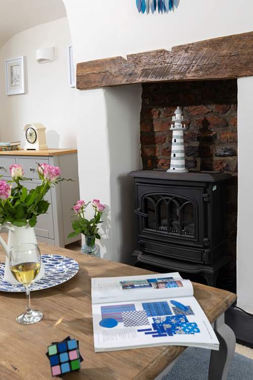 The gorgeous living-room has a wood-burner effect electric stove making this the perfect holiday cottage throughout the seasons.