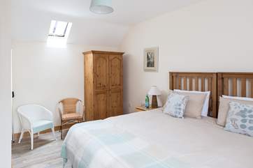 Another view of the master bedroom; one side has windows overlooking the farm buildings and the countryside beyond. The other side has a high Velux window that allows the light to flood in.