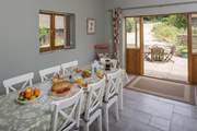 The kitchen/dining-room has French doors to the patio where you can watch the daily comings and goings of farm life.