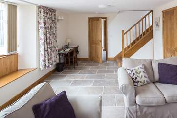 Stairs to the first floor and the door through to the ground floor shower-room with the kitchen/dining-room beyond.