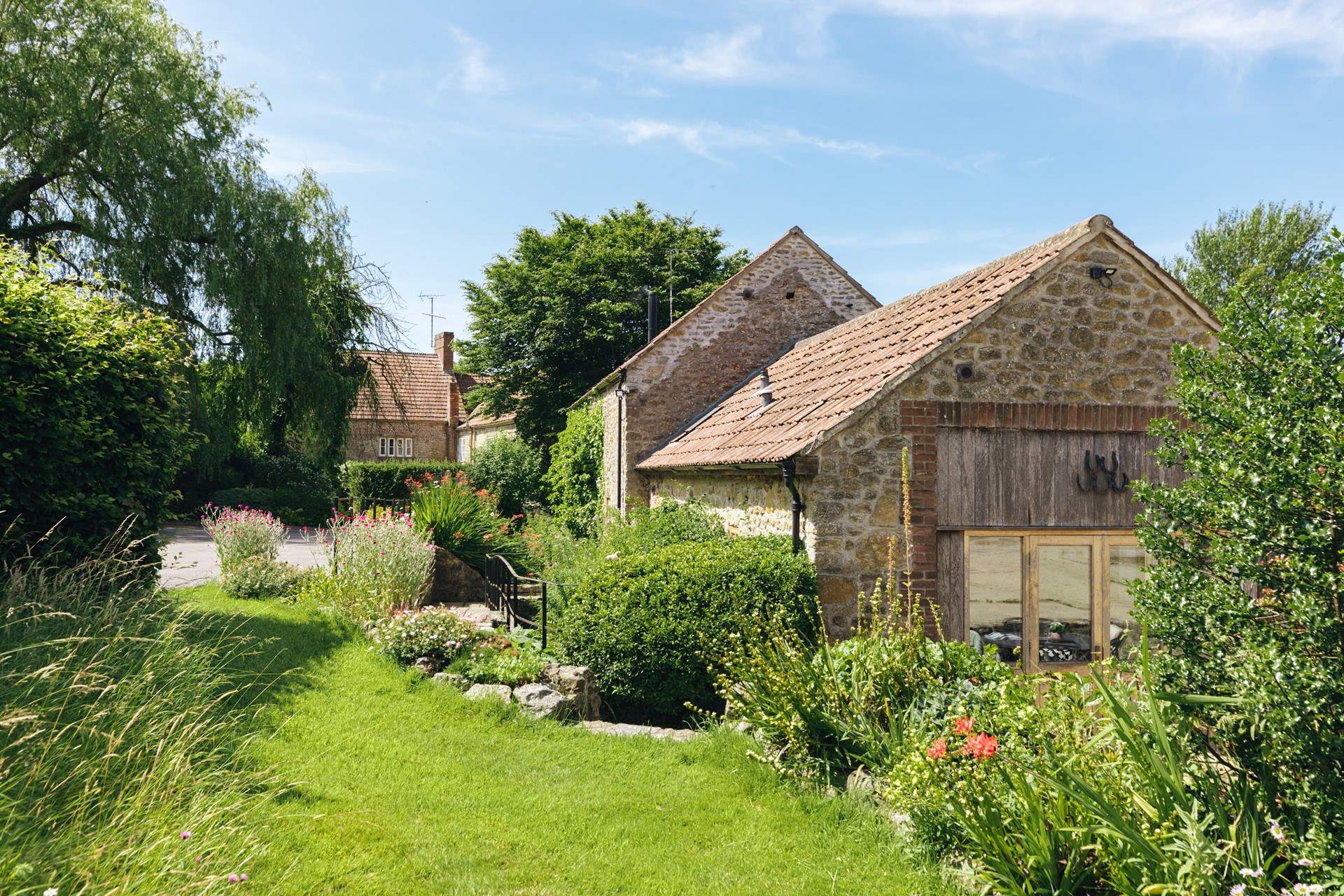 Up a few steps from the patio is a private lawned area for your use. (Please note it is not enclosed).