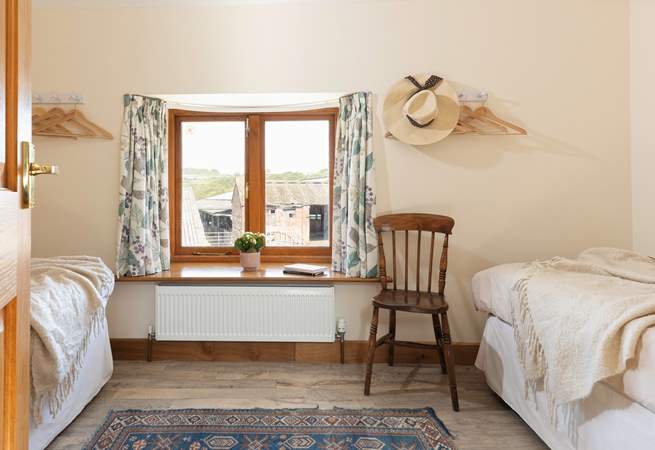 Peeking in to the first twin bedroom. There will often be livestock in the barns pictured through the window.