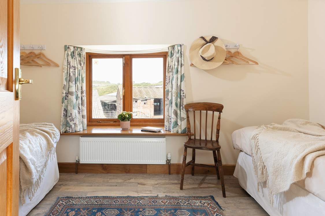 Peeking in to the first twin bedroom. There will often be livestock in the barns pictured through the window.