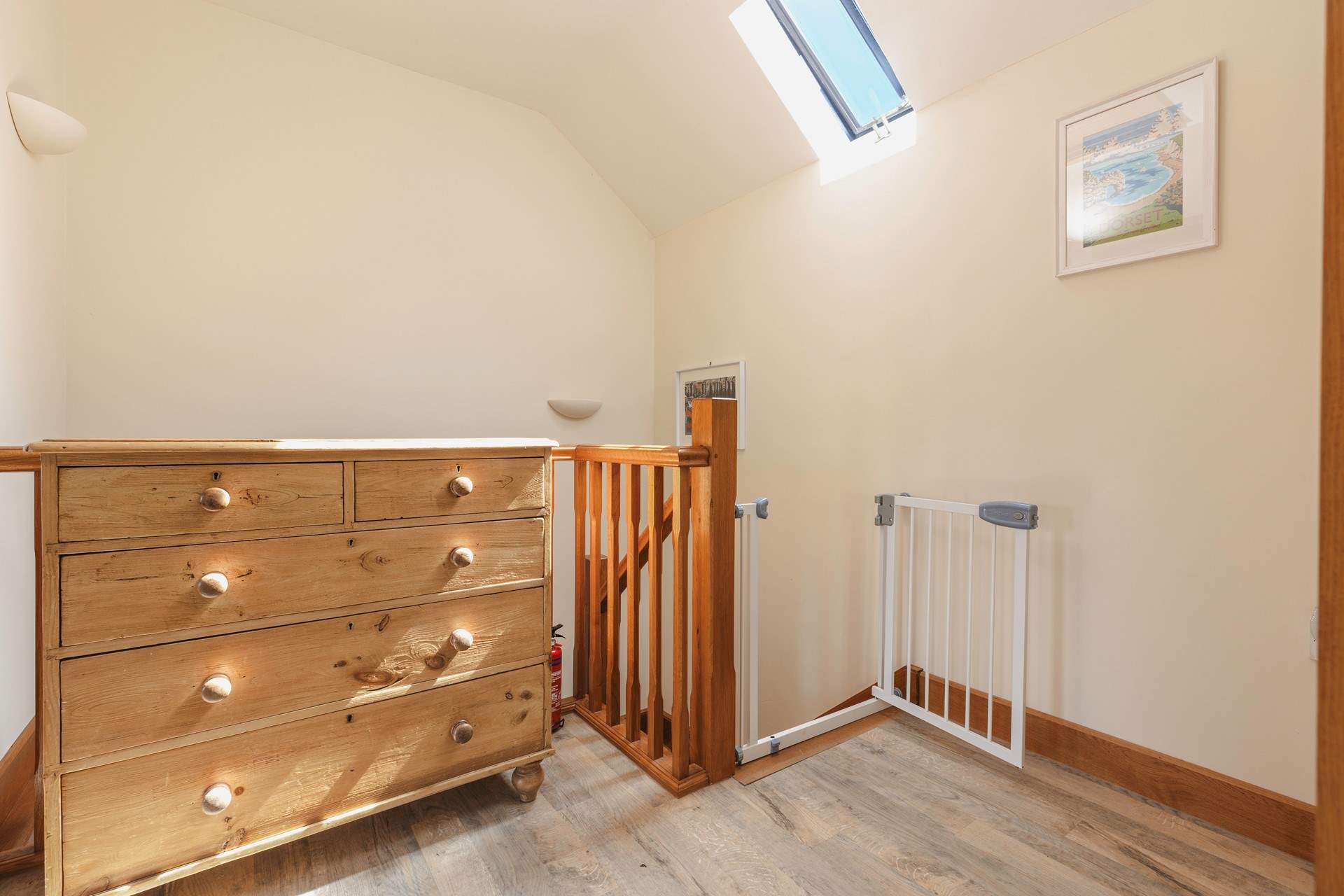 The hallway is bright and spacious, with a stair gate for your peace of mind.