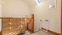 The hallway is bright and spacious, with a stair gate for peace of mind.