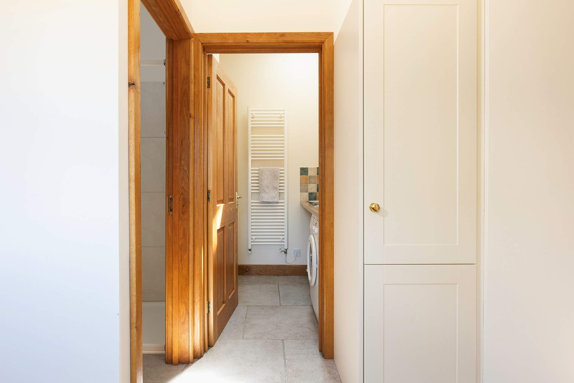 Straight ahead in this photo is the downstairs utility-room and WC and to the left is the shower.