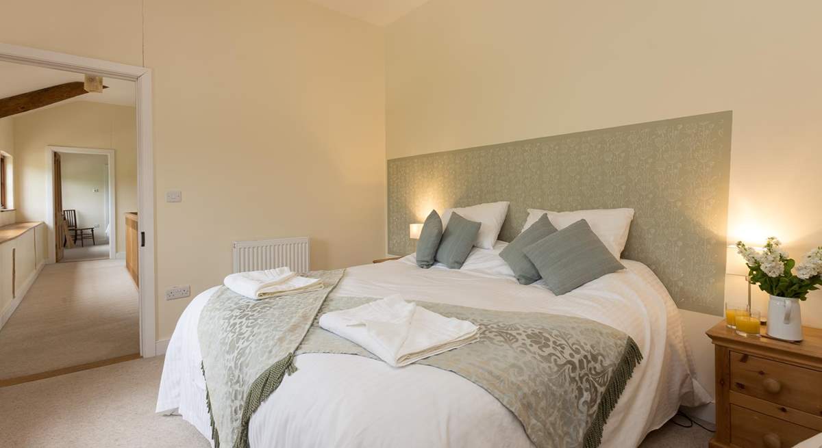 This bedroom looks out over the fields and up the hill at the back of the barn.