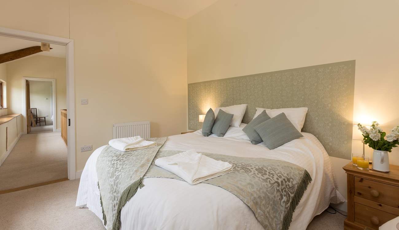 This bedroom looks out over the fields and up the hill at the back of the barn.