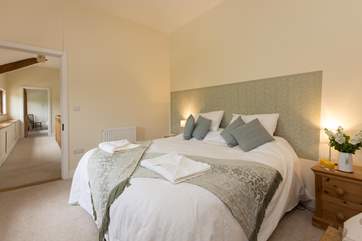 This bedroom looks out over the fields and up the hill at the back of the barn.