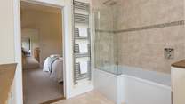 This bedroom has a bath with a fitted shower.