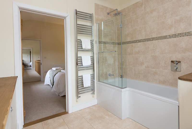This bedroom has a bath with a fitted shower.