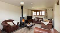 The sitting-room with its wood-burner and deep leather sofas is great for relaxing after a day out exploring.