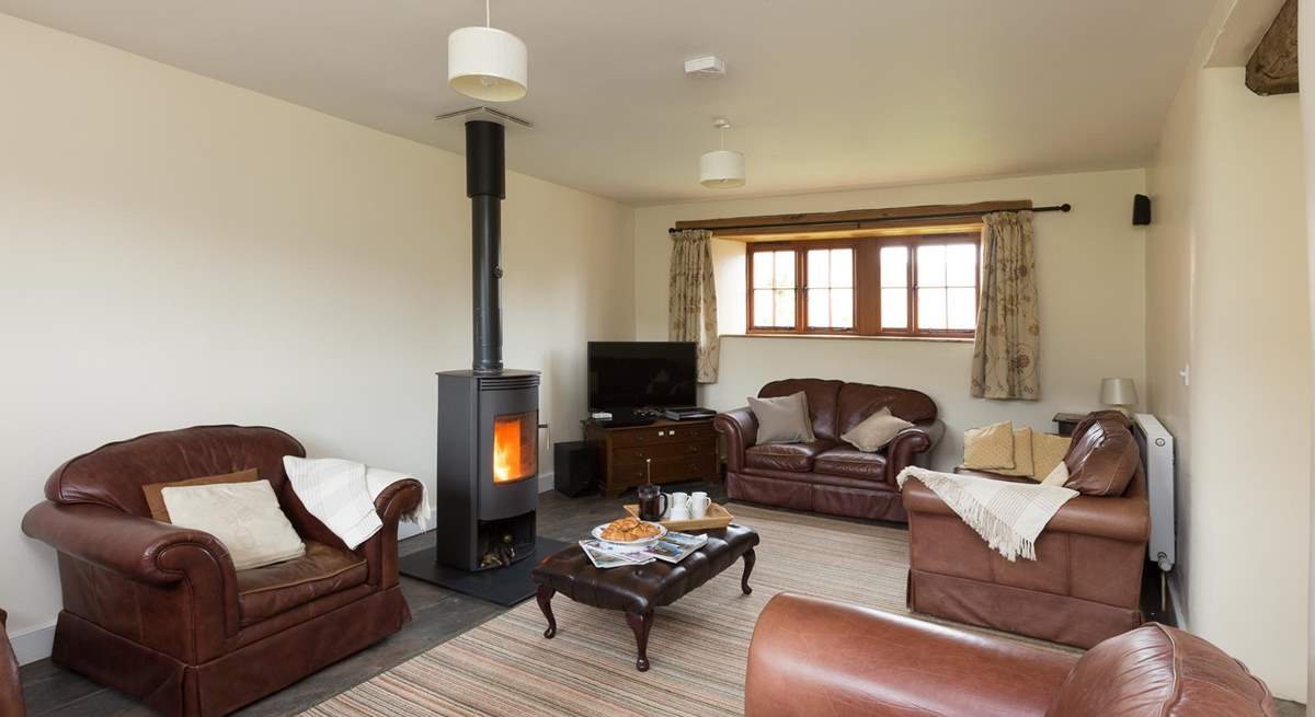 The sitting-room with its wood-burner and deep leather sofas is great for relaxing after a day out exploring.