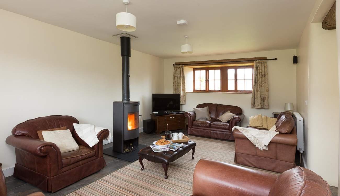The sitting-room with its wood-burner and deep leather sofas is great for relaxing after a day out exploring.