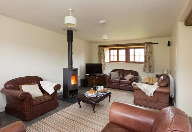 The sitting-room with its wood-burner and deep leather sofas is great for relaxing after a day out exploring.