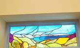 The stained glass window in the bedroom is beauitful, reflecting the stunning coastline outside. - Thumbnail Image