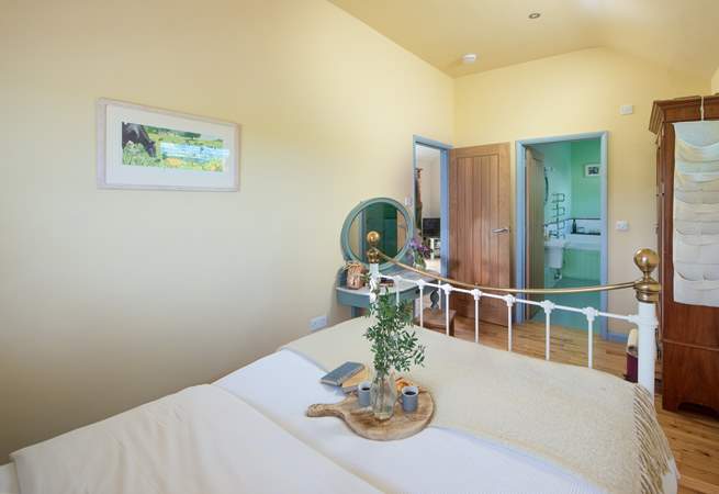 The pretty double bedroom has a feature bedstead. 