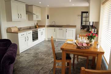 The kitchen is at one end with dining-area.