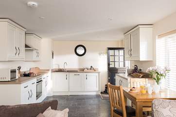 The well-equipped kitchen is at one end giving you space to cook, eat and relax.