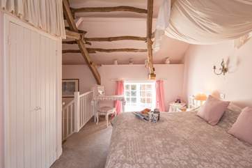 The bedroom is delightful from every angle.