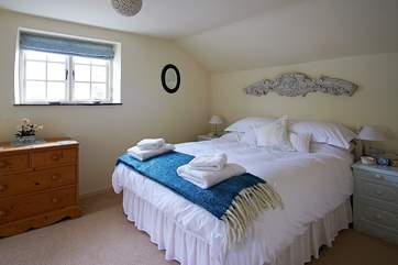 Bedroom 2 in Medlar Cottage (2595) has a lovely carving over the bed, a chance find by the owner in a French antique fair.