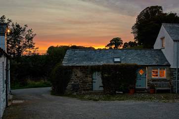 The exterior of Medlar Cottage (2595) with the sun sinking slowly in the west.