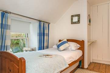 The single bedroom looks out across the garden at the front of the cottage.