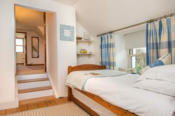 The single bedroom leads to the double bedroom (up three stairs) and the en suite.