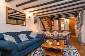 The open-tread staircase at the back of the sitting-room leads up to the bedrooms.