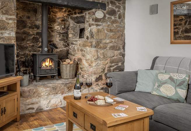 The traditional sitting-room is very cosy with its beamed ceiling and granite inglenook.