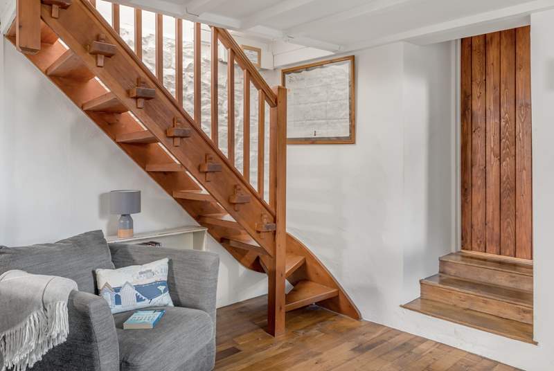 The polished oak open-tread staircase at the back of the sitting-room leads up to the bedrooms.