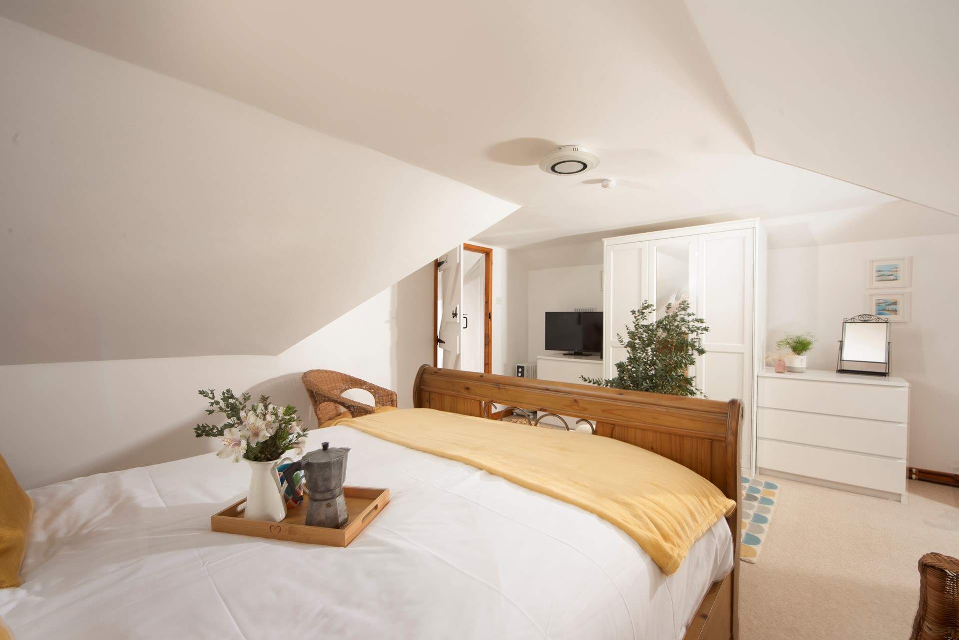 The principal bedroom has plenty of space and it tucked away for a good night's slumber. 