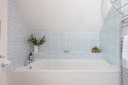 The lovely big tub in the en suite bathroom to the principal bedroom.