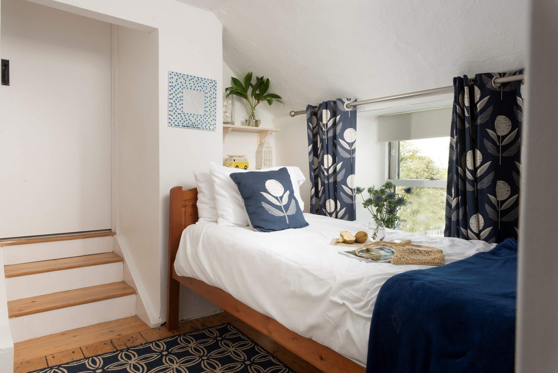 The single bedroom leads up three steps  to the principle bedroom and the en suite.