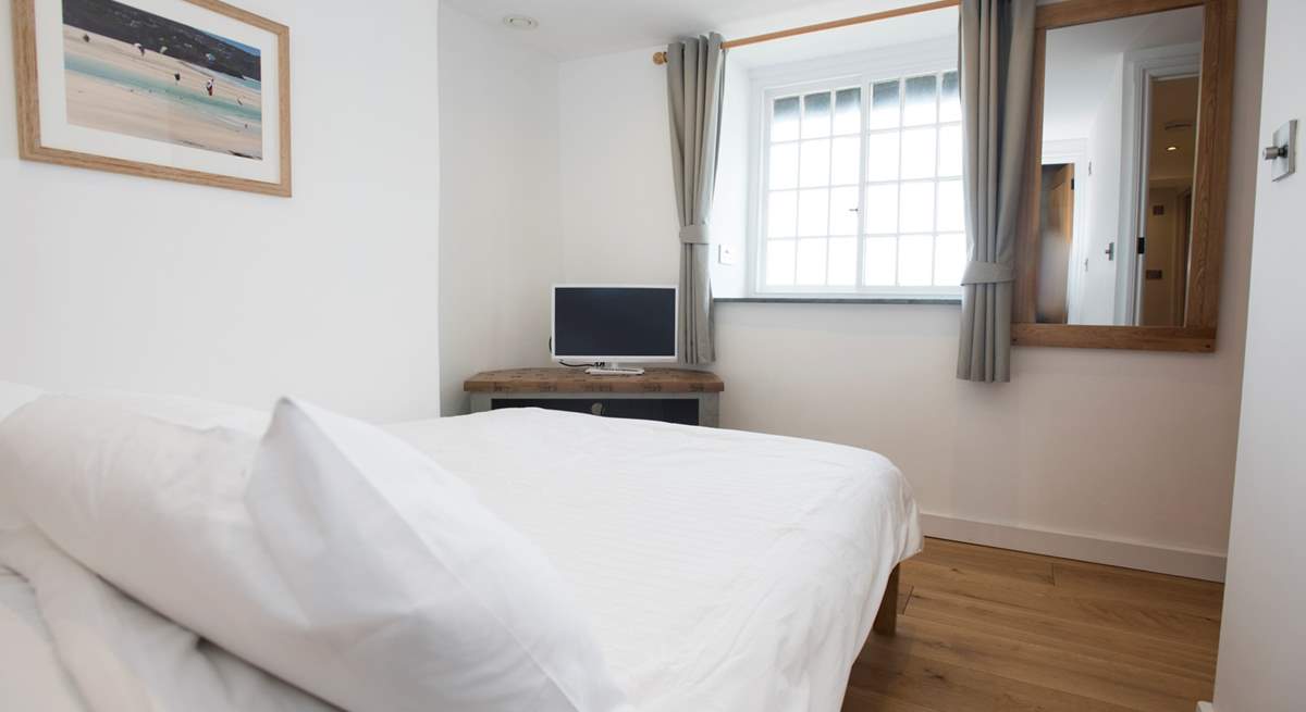 The first floor double bedroom has a television and great sea views.