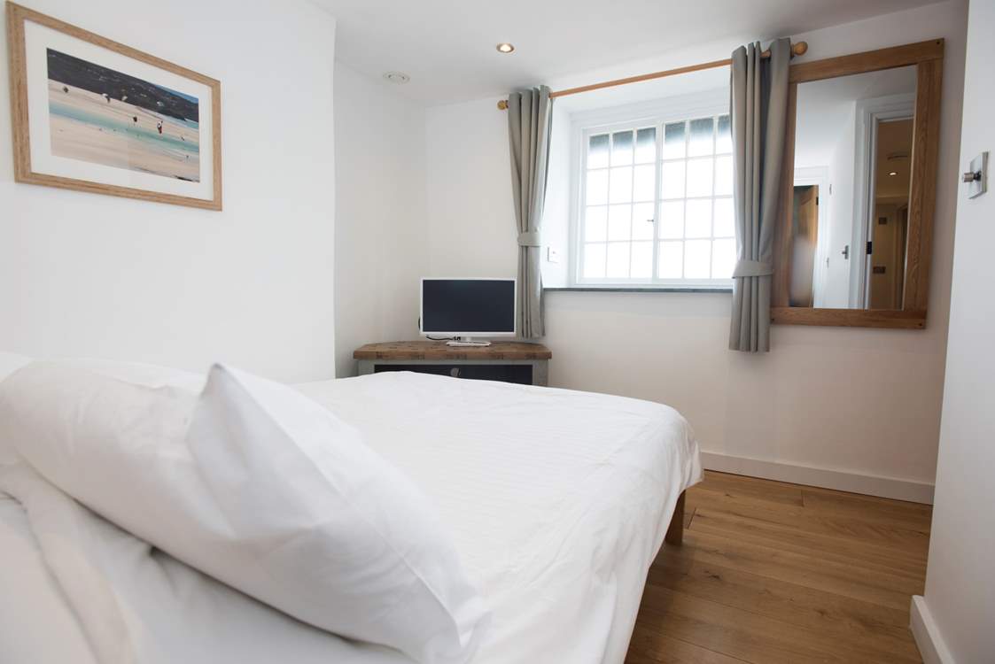 The first floor double bedroom has a television and great sea views.
