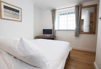 The first floor double bedroom has a television and great sea views.