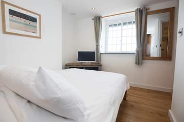 The first floor double bedroom has a television and great sea views.